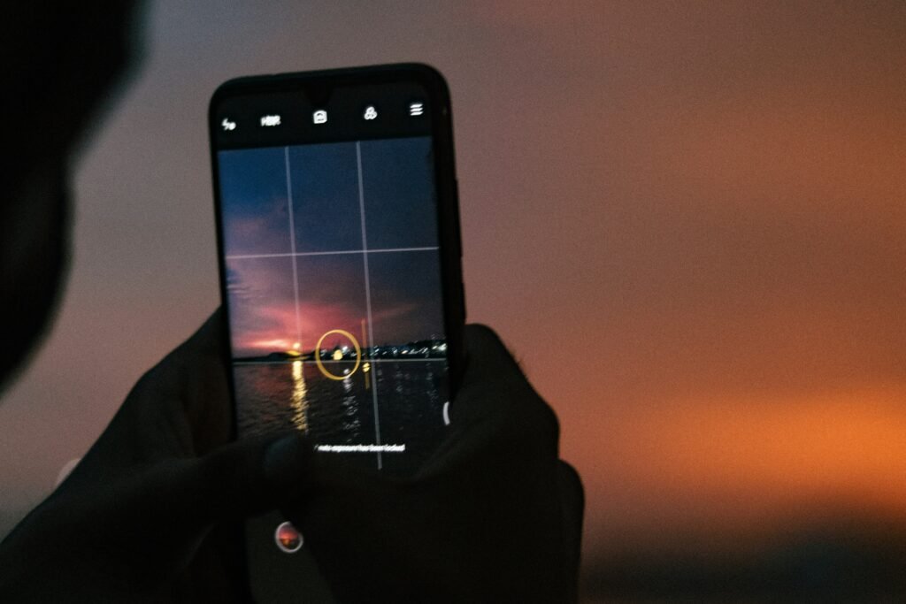 a person taking a picture with a cell phone