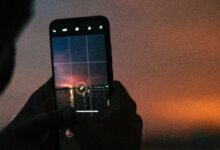 a person taking a picture with a cell phone