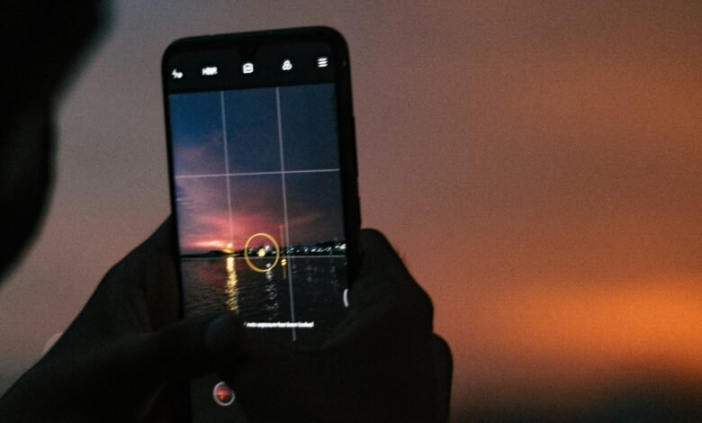 a person taking a picture with a cell phone